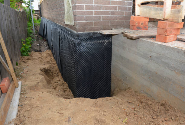 SJ Waterproofing Pros technician performing targeted Basement Waterproofing assessment in Hudson, MI